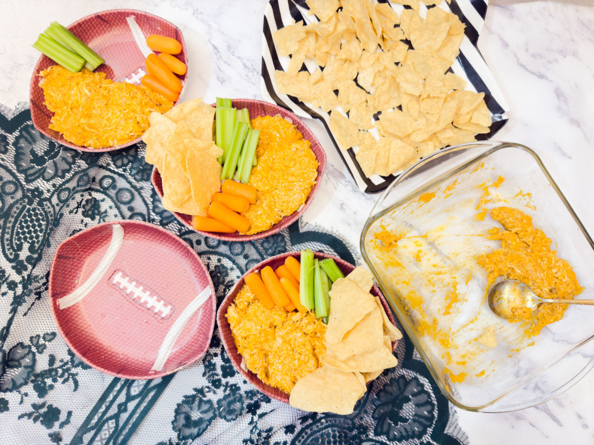 transferring chicken dip to bowl