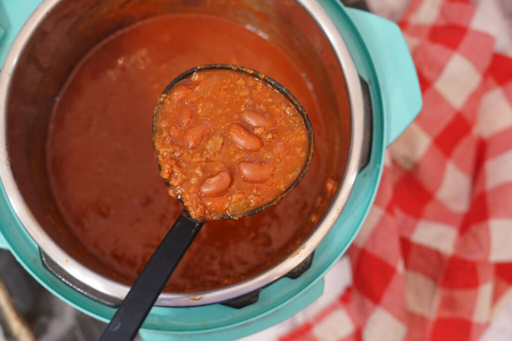 Mixing turkey chili ingredients