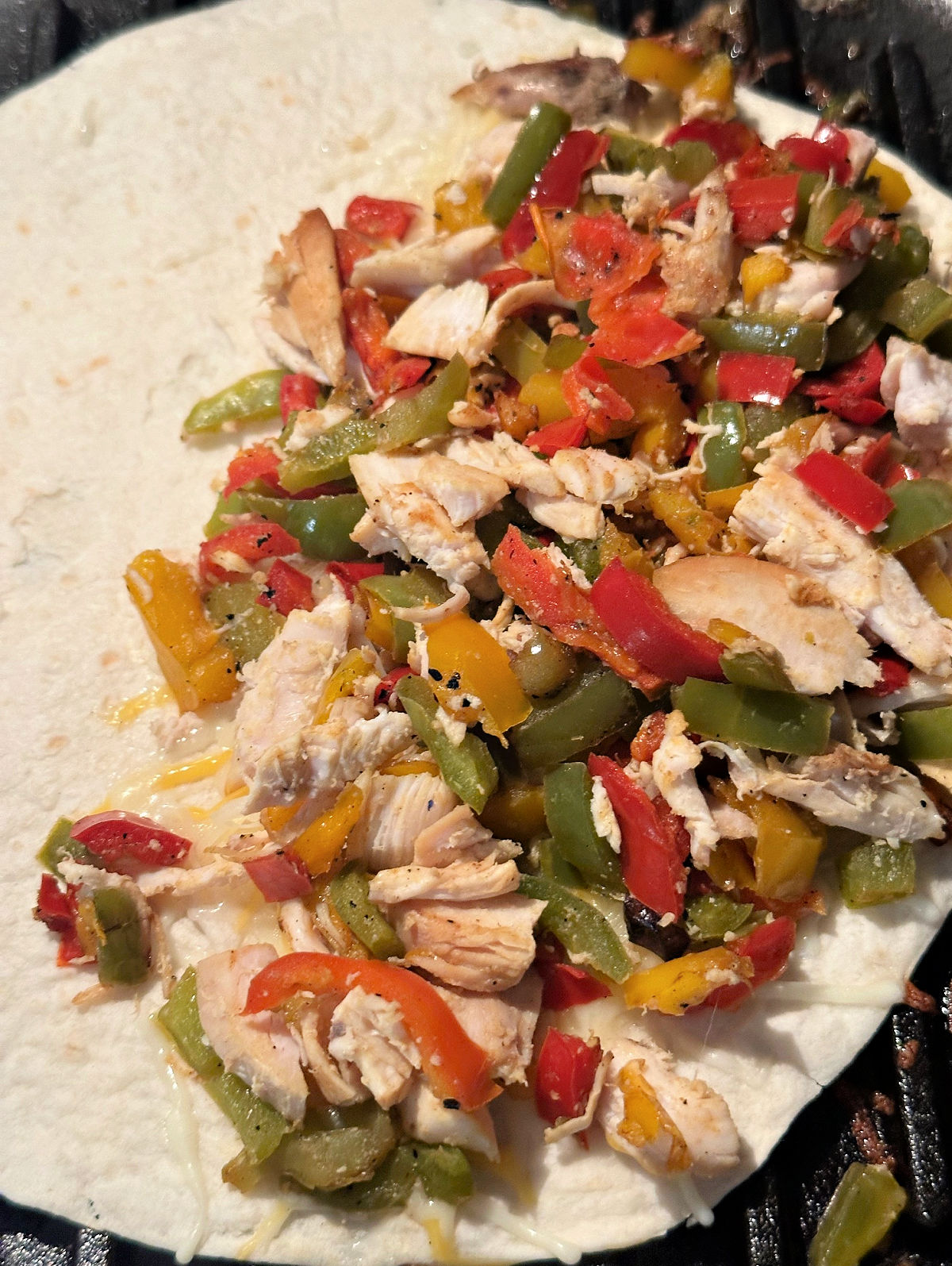 chicken quesadilla with ingredients on half