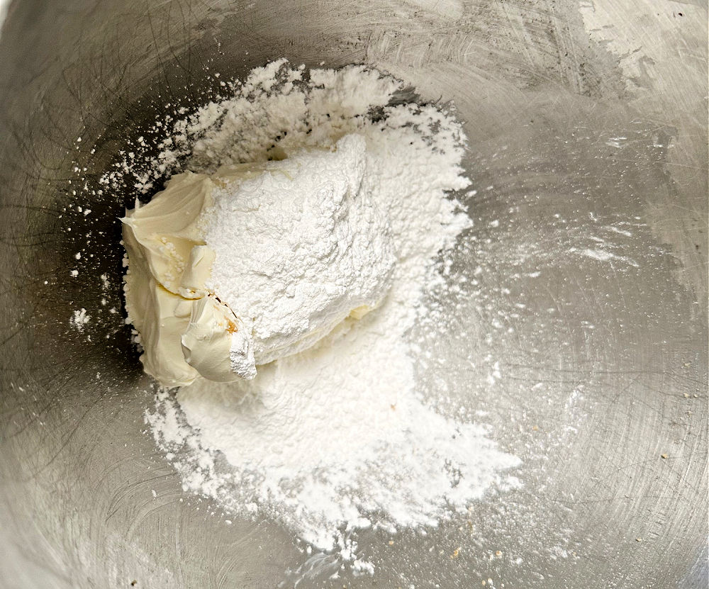 mixing sugar and cream cheese