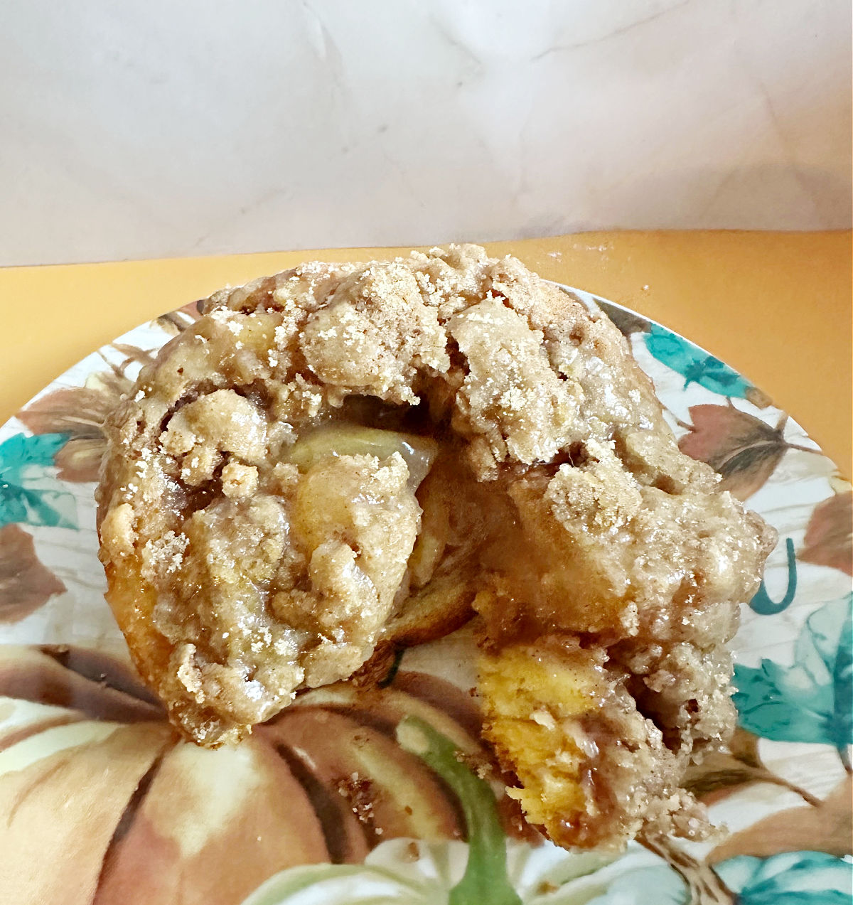 cutting into Apple Pie Cinnamon Roll Muffins