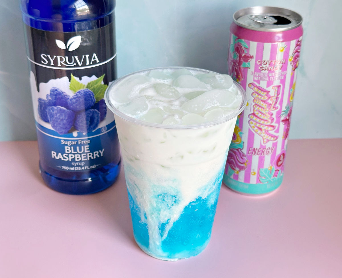 adding cream to Cotton Candy Dirty Alani Drink 