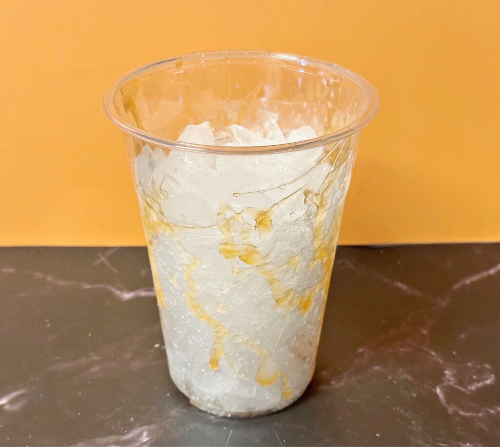adding ice to plastic cup