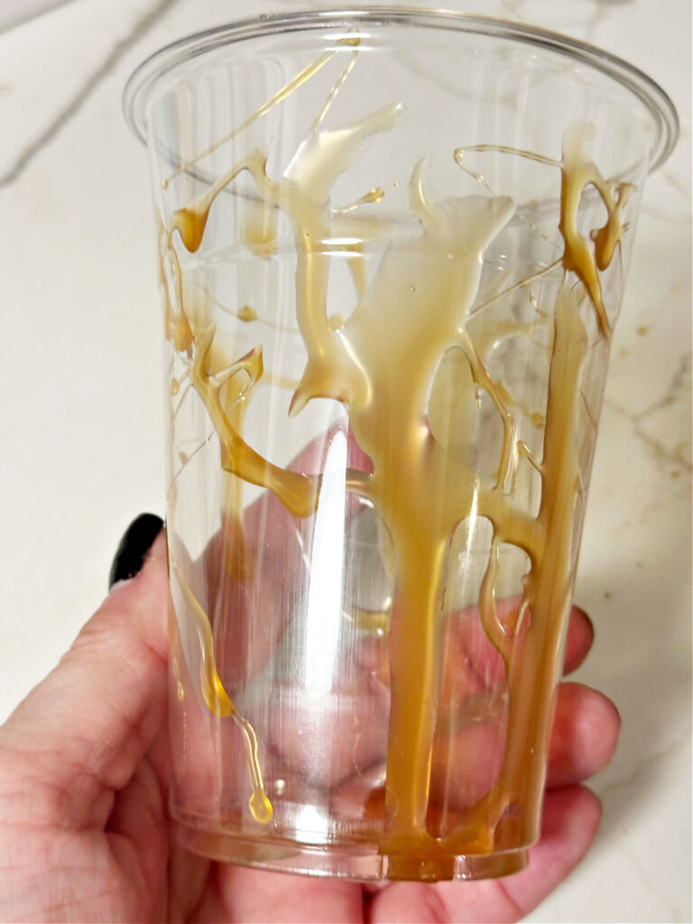 adding caramel to cup