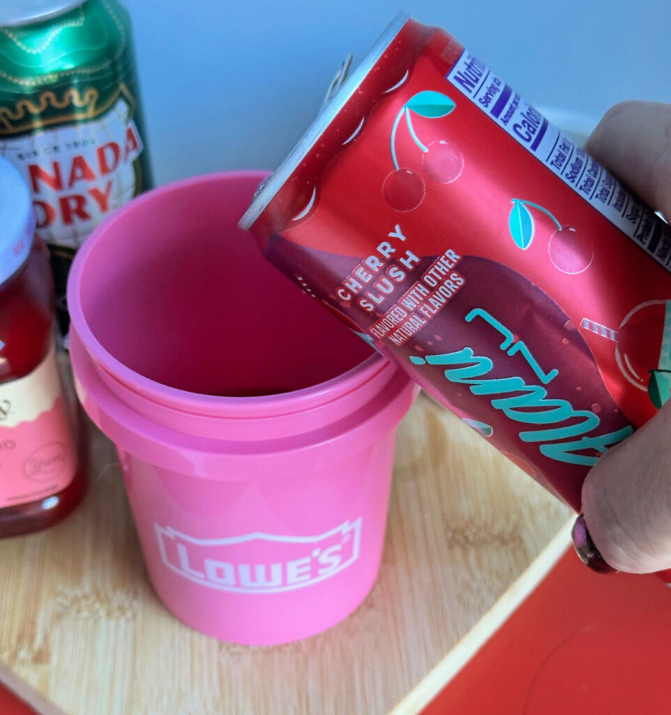 pouring alani in pink bucket cup