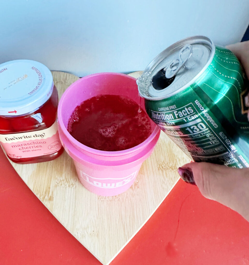 pouring ginger ale in bucket cup