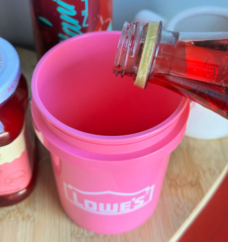 pouring grenadine in bucket cup