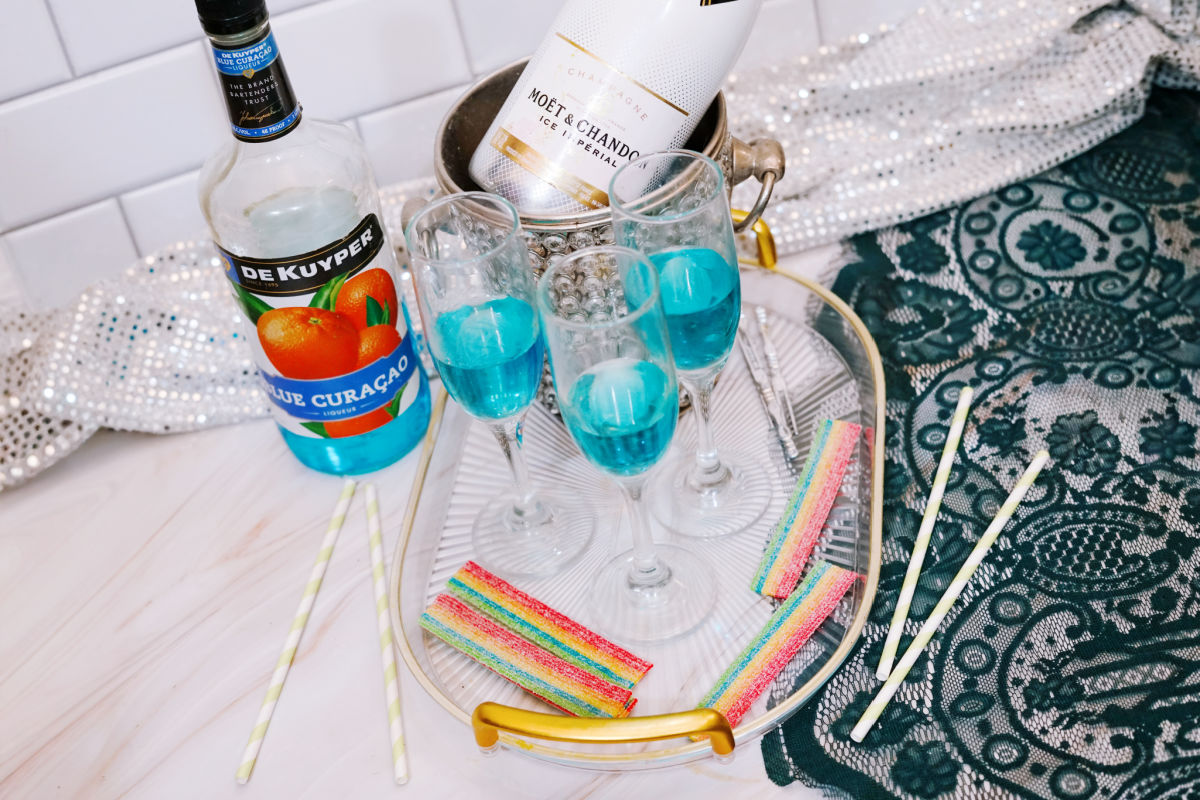 champagne glass filled with blue curacao