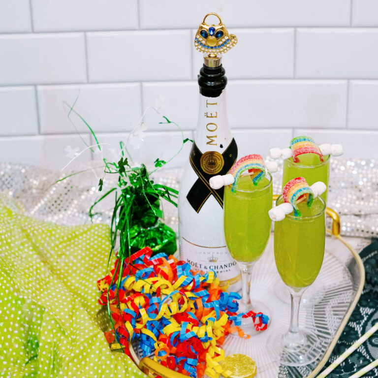 Green mimosa made with blue curaçao and champagne in a champagne flute