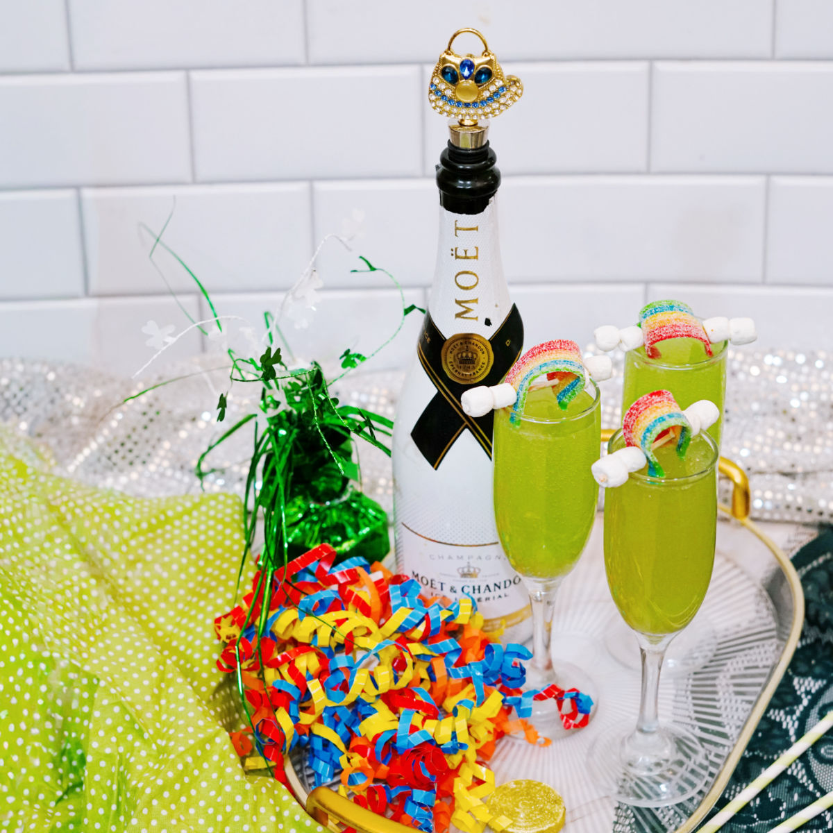 Green mimosa made with blue curaçao and champagne in a champagne flute