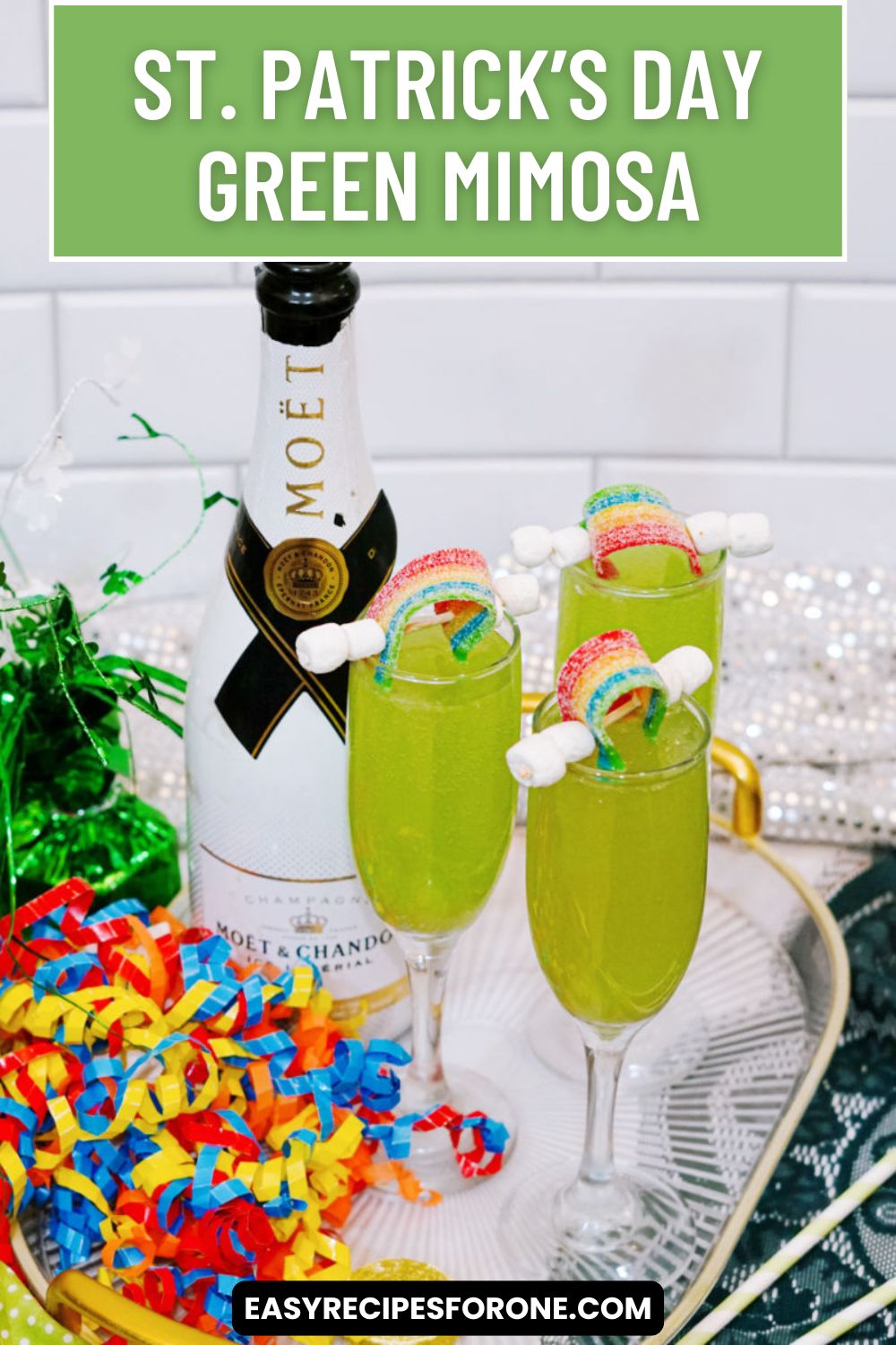 3 st. patrick's day mimosas with rainbow candy garnish